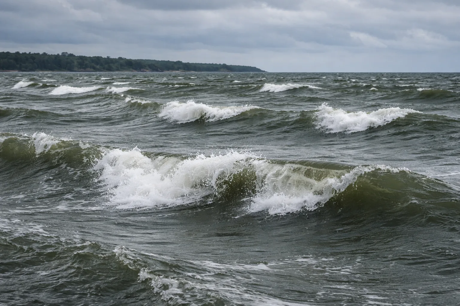 Sailboat checking wind conditions on open water with whitecaps visible